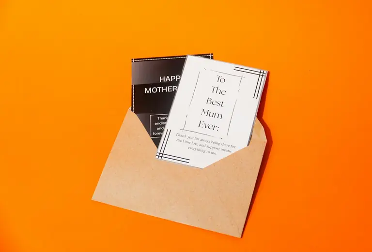 Mother's day card and envelope on orange background