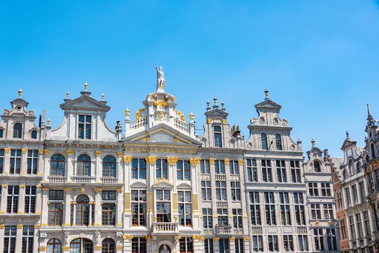 Beautiful historic facades at Grand Place, Brussels under a clear blue sky.