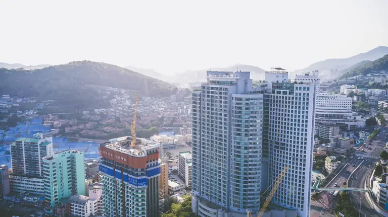 Aerial shot of modern high-rise buildings in a bustling urban cityscape.